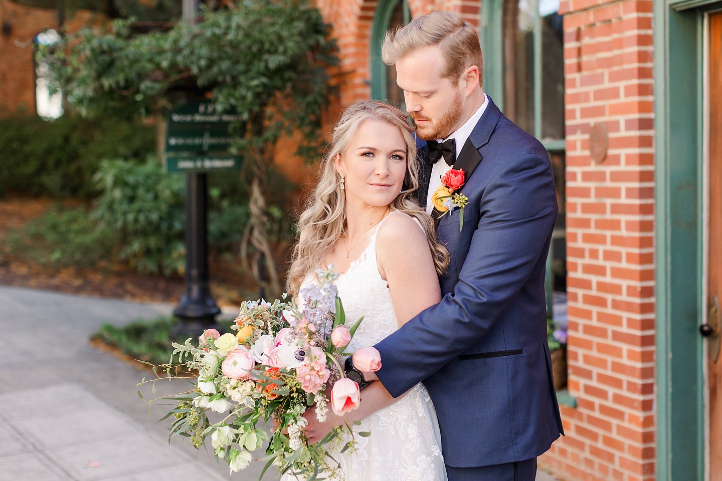 bride and groom portrait in front of Huguenot Mill in Greenville