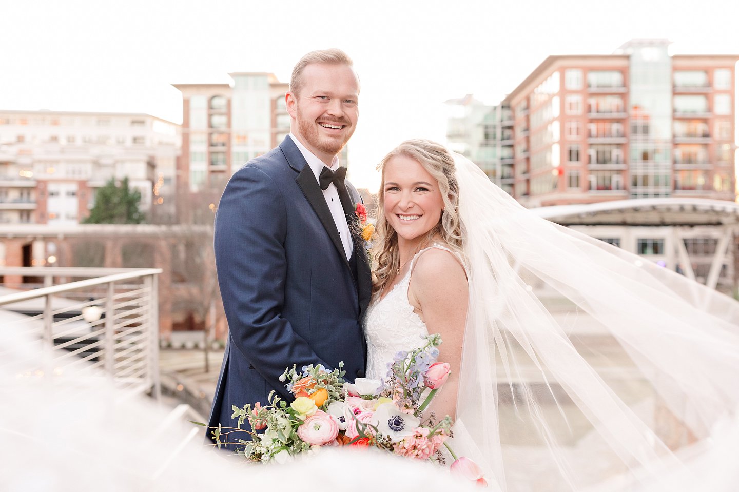 downtown Greenville bride and groom portrait with veil flying